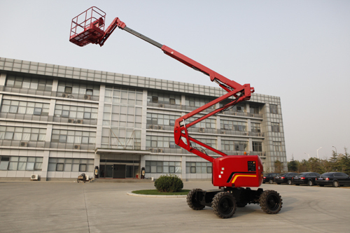 12 meter articulated boom lift elevated near commercial building for maintenance work