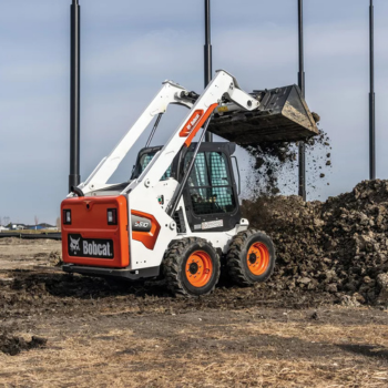 Bobcat skid steer rental loading dirt at construction site