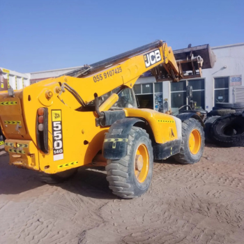 Boom loader rental machine lifting materials at construction site