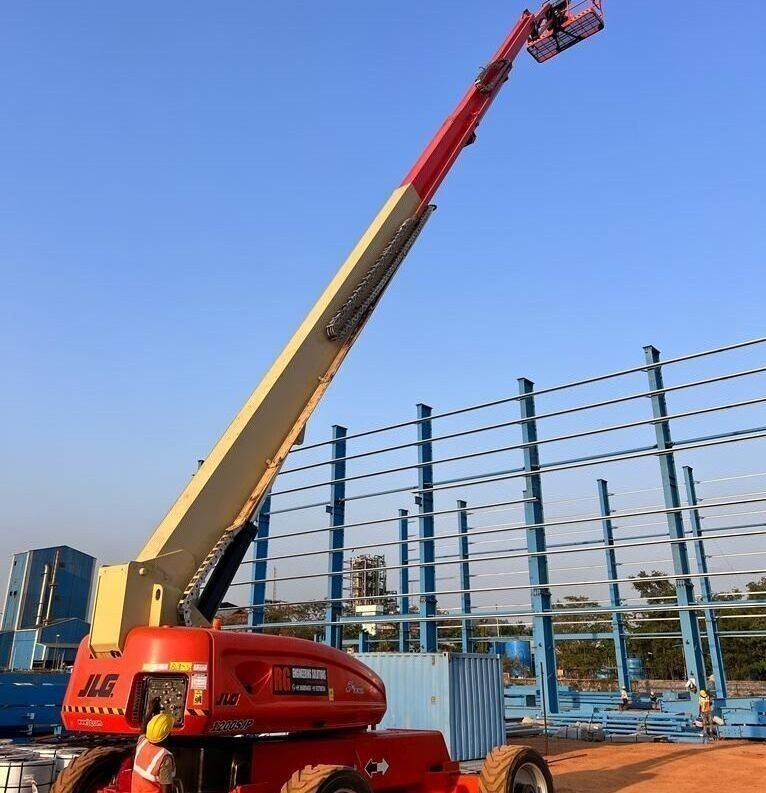 articulated boom lift working at construction site in Dubai